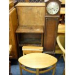 OAK CASED POLISHED GRANDMOTHER CLOCK , dome topped with silver dial, a small oval coffee table, a