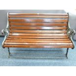 A VINTAGE CAST IRON AND SLATTED-SEAT GARDEN BENCH, 75.5cms height, 126cms width, 65cms depth