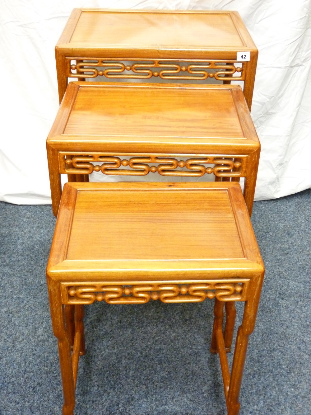 ORIENTAL HARDWOOD COFFEE TABLES, a nest of three oblong topped with patterned aprons and 'bamboo - Image 2 of 5