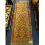 A VEGETABLE DYE WOOL CHOBI KELIM RUNNER colourful repeating central diamond block pattern with