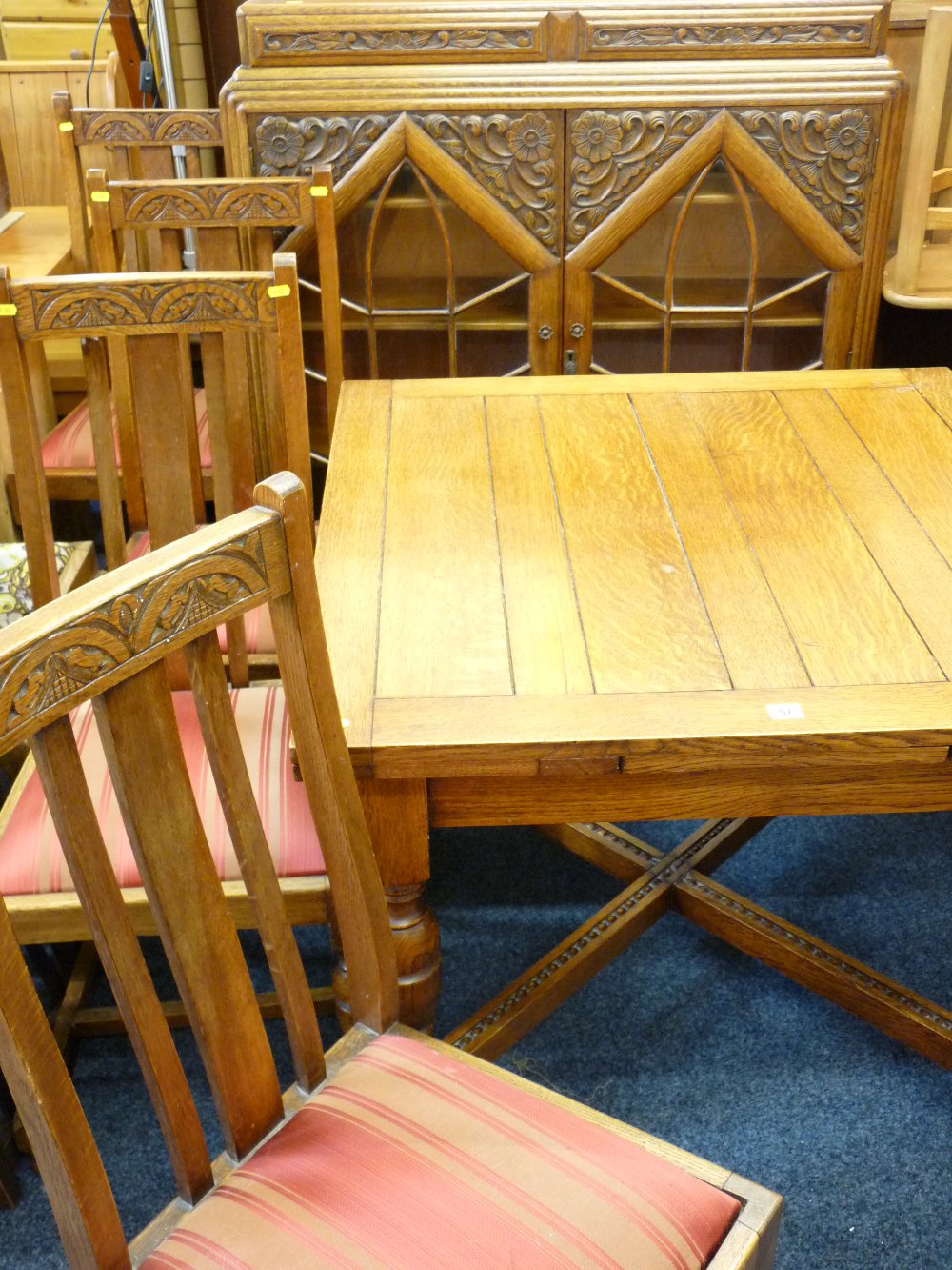 AN OAK DINING SUITE, draw leaf dining table with turned supports and cross stretcher four high