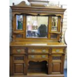 A WELL PRESENTED EDWARDIAN CARVED OAK MIRROR BACK SIDEBOARD, the triple mirror top with