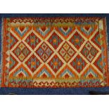 A VEGETABLE DYE WOOL CHOBI KELIM RUG, repeating central diamond block pattern on a colourful