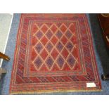 A CAZAK RUG central block diamond pattern on a red ground with multi bordered edge, 126 x 110cms