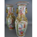 A PAIR OF CANTON FAMILLE ROSE DECORATED VASES, late 19th Century with gilt salamanders in relief and