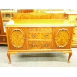 A WELL PRESENTED FIGURED WALNUT SIDEBOARD with shaped back rail, central lower drawers and carved