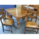 A VICTORIAN MAHOGANY WIND-OUT DINING TABLE and a set of five (4+1) oak dining chairs with rexine