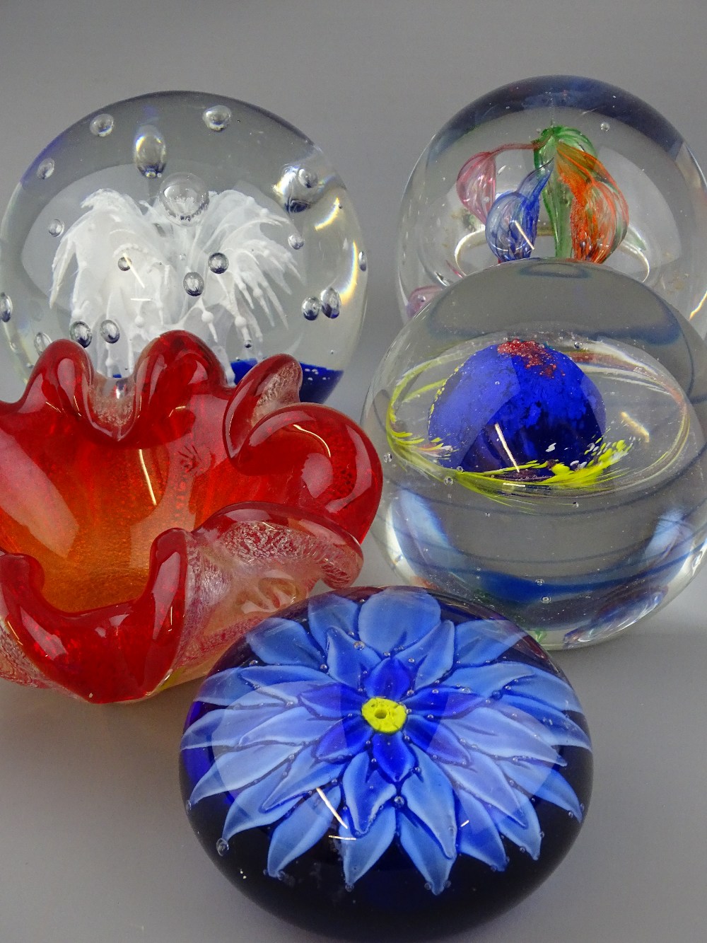 THREE GOOD SIZED GLASS PAPERWEIGHTS, another and an art glass dish