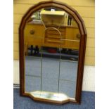 A STYLISH MAHOGANY EFFECT WALL MIRROR with small lower shelf, 104cms height, 67cms width