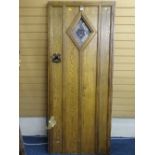 A VINTAGE OAK HEAVY GAUGE HANDLE ENTRANCE DOOR with stained glass diamond shape panel and iron pull,