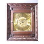 A MATTHEW BUSHELL SQUARE BRASS CLOCK DIAL with wall clock movement housed in a glazed door front