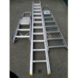 AN EXTENDING ALUMINIUM LADDER and two sets of step ladders, 5.1m open, the extender