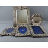 THREE PIERCED SILVER PHOTOGRAPH FRAMES, a similar easel mirror, 29.5 x 22.5cms Birmingham 1848,