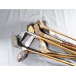 ELEVEN ANTIQUE GOLF CLUBS - all wooden handled, being four irons and seven woods in various