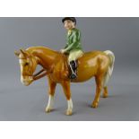 BESWICK MODEL OF A PALOMINO WITH GREEN JACKET RIDER and black Beswick back stamp, 13.5cms height,
