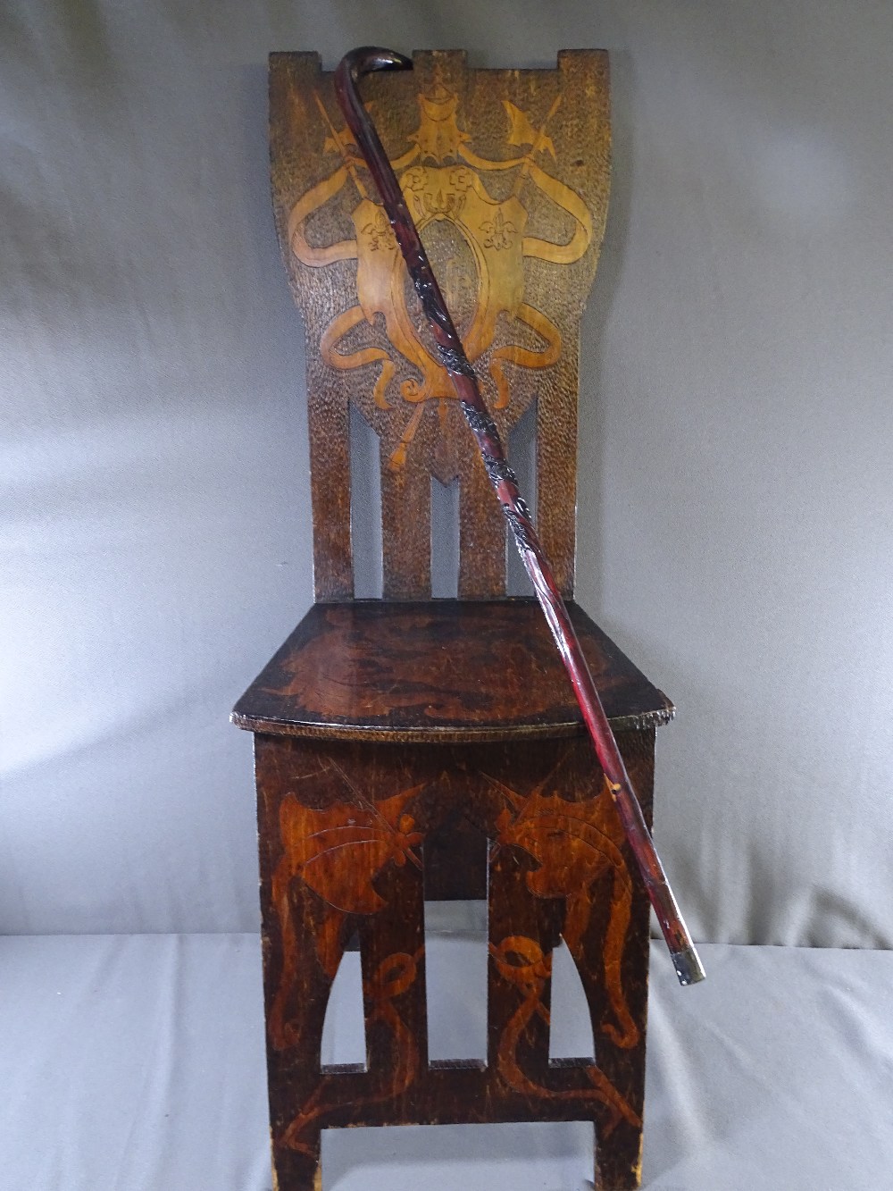 EISTEDDFOD POKERWORK CHAIR and a walking stick with raised carving