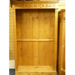 ANTIQUE PINE BOOKSHELF with floral carved frieze to the top, 215cms height, 123cms width, 136cms