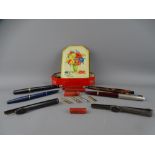 FOUR VINTAGE FOUNTAIN PENS and two steel holders with a small quantity of nibs and sealing wax in