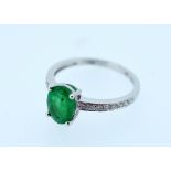 14CT WHITE GOLD EMERALD & DIAMOND RING featuring central oval cut medium green emerald (1.16ct),