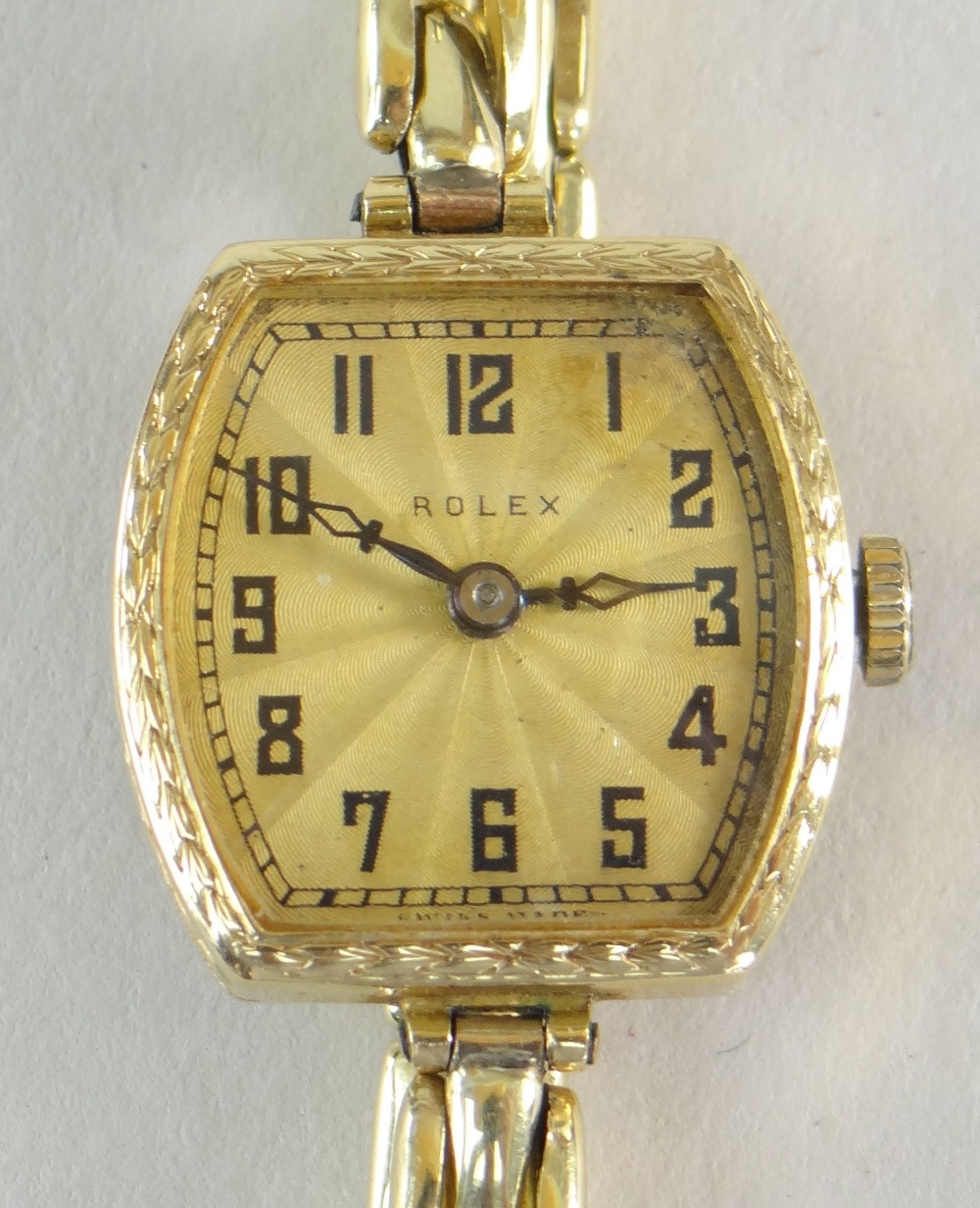 A VINTAGE LADIES 18CT YELLOW GOLD ROLEX WRISTWATCH with elegant guilloche dial bearing black