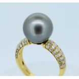 14CT YELLOW GOLD PEARL & DIAMOND RING featuring one cultured South Sea pearl with fifty-six round