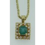 YELLOW METAL (BELIEVED 18CT GOLD) EMERALD & DIAMOND PENDANT ON 18CT GOLD CHAIN, the central
