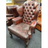 RED LEATHER CHESTERFIELD / CLUB TYPE WING-BACK ARM CHAIR on carved ball and claw supports