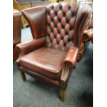 BUTTONED BACK RED LEATHER CHESTERFIELD / CLUB TYPE WING-BACK ARM CHAIR on reeded supports