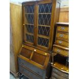 VINTAGE OAK BUREAU BOOKCASE on raised baluster legs with lead glazed upper doors