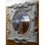 IMPOSING REPRODUCTION PAINTED FRAME OVAL-PANEL MIRROR with bevel glass, applied flowers and