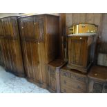 GOOD VINTAGE CROWN BEDROOM SUITE with carved Gothic and linen-fold decoration, comprising two drawer