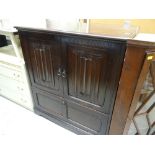 DARK OAK LINEN-FOLD STYLE ENTERTAINMENT CABINET, together with a vintage mahogany break-front