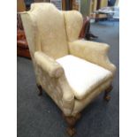 GOOD QUEEN ANNE STYLE WING BACK ARM CHAIR in gold floral upholstery, with carved ball and claw