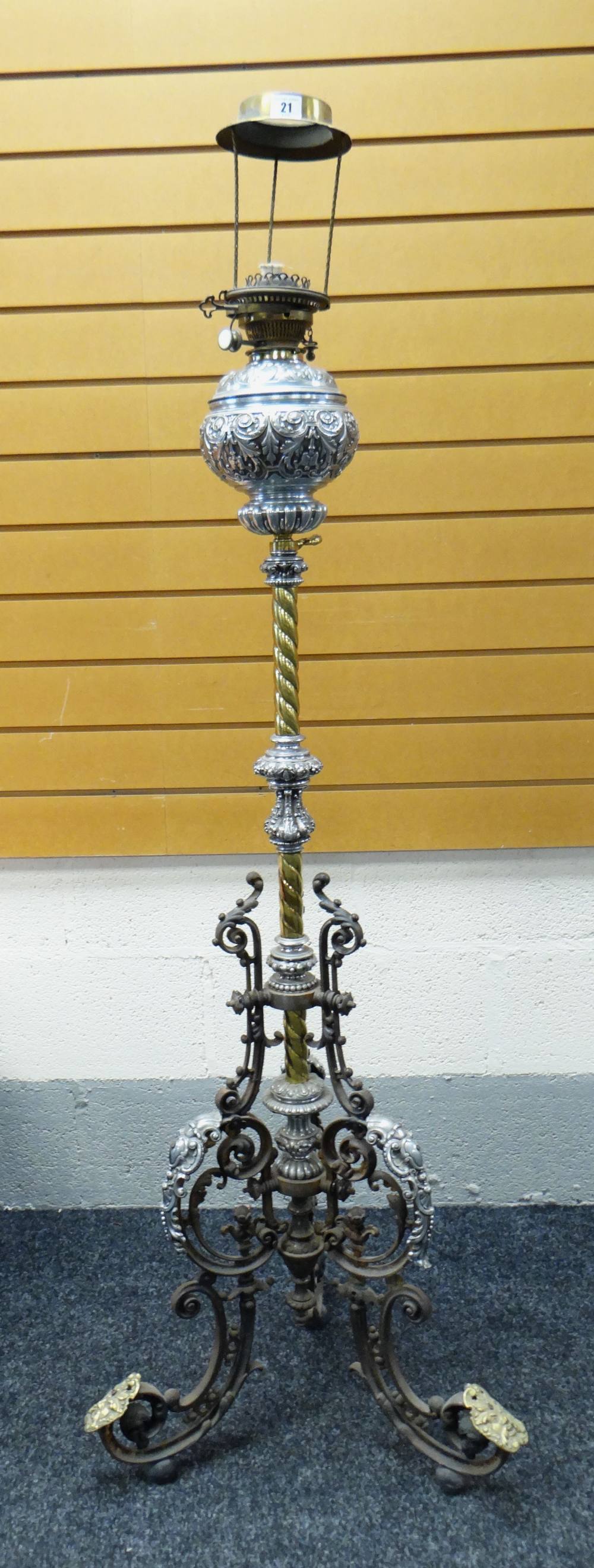 HIGHLY ORNATE METAL OIL LAMP STANDARD with scroll and foliate tripod feet, the column with brass and