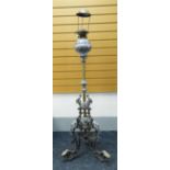 HIGHLY ORNATE METAL OIL LAMP STANDARD with scroll and foliate tripod feet, the column with brass and