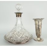 CUT GLASS SHIP'S DECANTER with silver collar raised on silver and turned wooden stand, mixed