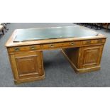 LARGE TURN OF THE CENTURY OAK PARTNERS DESK having two opposing banks of eight drawers, green