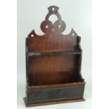 NINETEENTH CENTURY MIXED WOOD SPOON RACK with geometric open work frieze, 16cms high