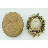 LAVA TYPE CAMEO BROOCH, together with another cameo brooch with scroll and foliate surround, box