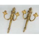 PAIR OF FINE QUALITY ANTIQUE GILT METAL CANDLE SCONCES in the Classical-style with twin branches,
