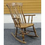 20TH CENTURY OAK WINDSOR TYPE ROCKING CHAIR with shaped and pierced centre splat