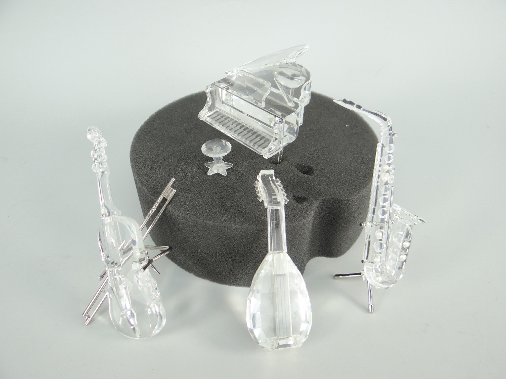 FOUR BOXED SWAROVSKI CRYSTAL MUSICAL INSTRUMENT ORNAMENTS