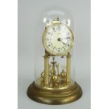 GERMAN GILT METAL ROTARY CLOCK in a glass dome with circular enamel dial by Schatz