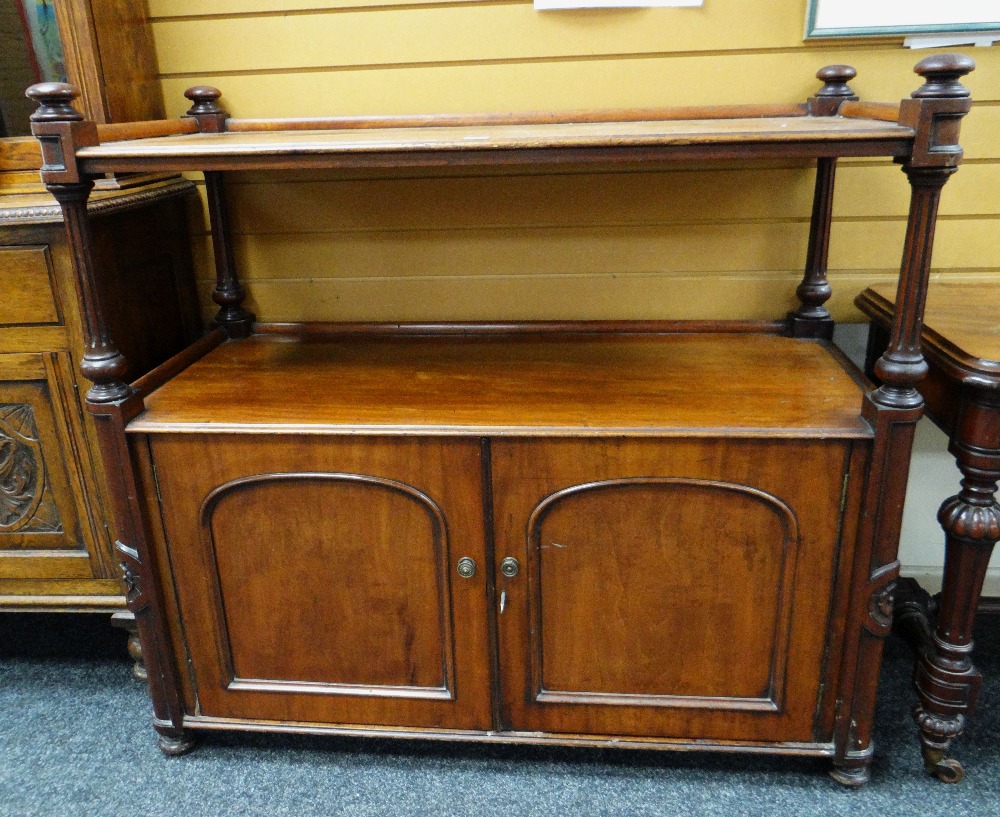 VICTORIAN MAHOGANY DUMBWAITER having a two door cupboard base and with carved and fluted supports,