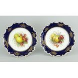 PAIR OF ROYAL WORCESTER PORCELAIN DISPLAY PLATES, the interiors painted with fruit by Richard