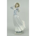 LLADRO PORCELAIN FIGURE OF A LADY struggling to keep her hat in a gust