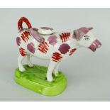 SWANSEA CAMBRIAN POTTERY COW CREAMER with pink-lustre and iron-red markings, green shaped oval base,