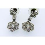 PAIR OF 18CT WHITE GOLD DIAMOND DROP EAR RINGS, the seven stone flower head drops suspended by