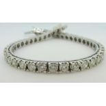 DIAMOND LINE BRACELET of forty-six round cut diamonds, approx 10-12cts total, set in 18ct white