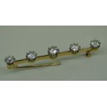 YELLOW METAL FIVE-STONE DIAMOND BAR BROOCH having a diamond total of 1.5ct approximately in